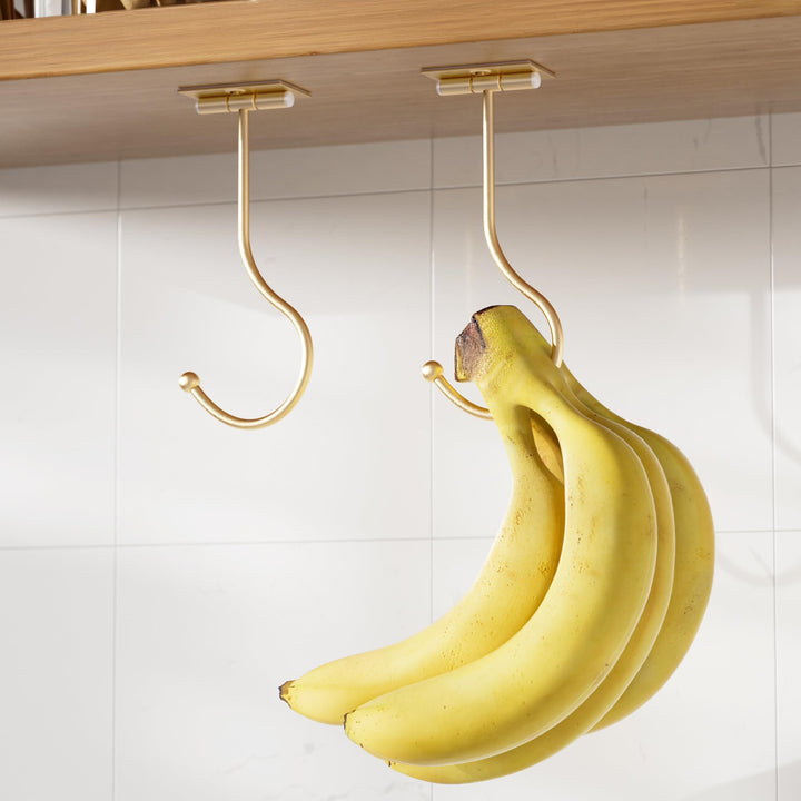 Gold Banana Holder Under Cabinet - Folding Banana Hook, Adhesive Banana Hanger, Folds Up with Magnets When Not in Use, Keep Bananas Fresh, 2 Pack